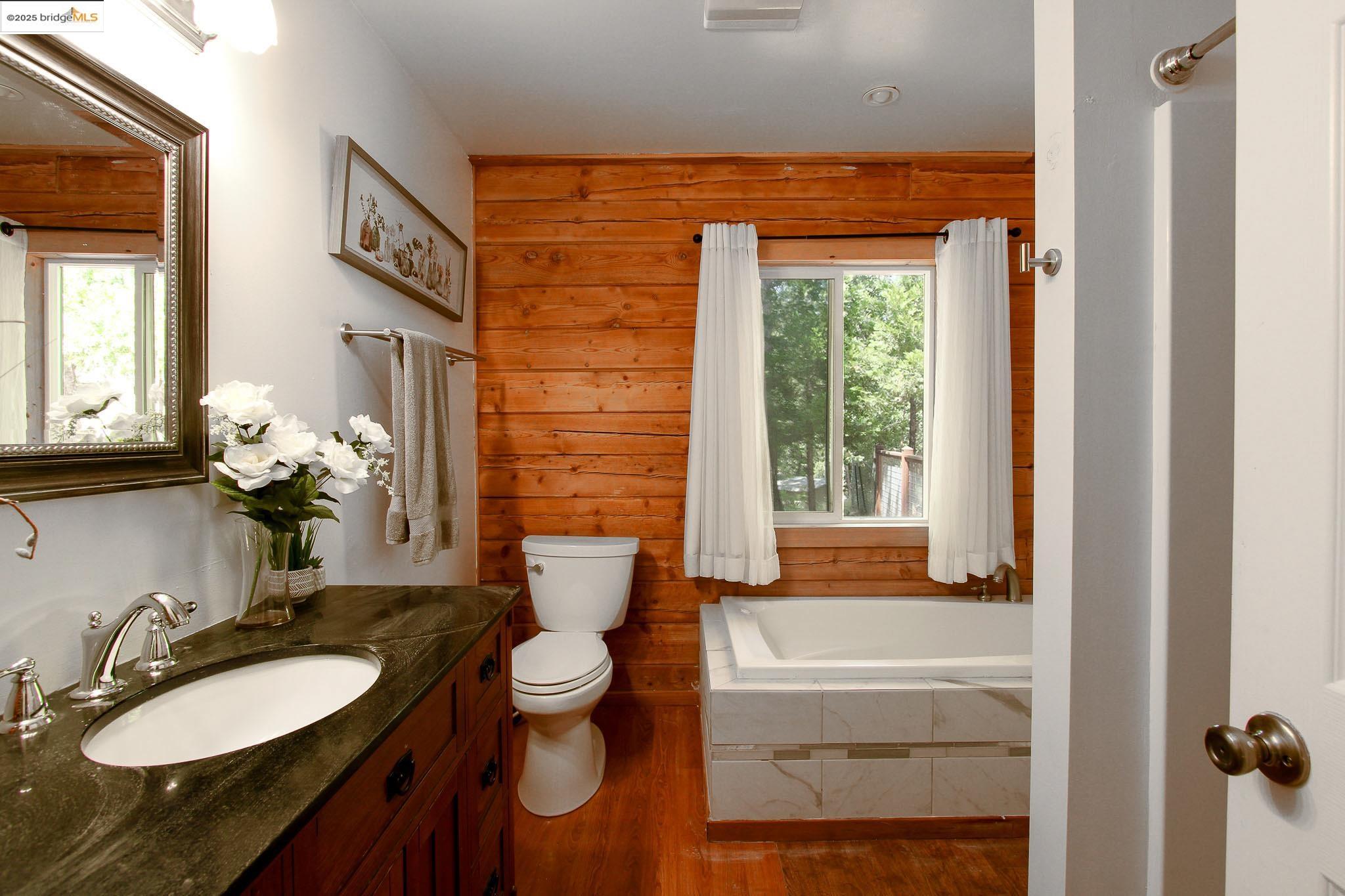 2936 Highway 4 Murphys, CA 95247 - Photo 37 of 41 a bathroom with a granite countertop sink and a mirror
