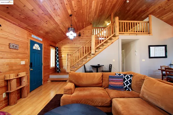 a living room with furniture a ceiling fan and a rug