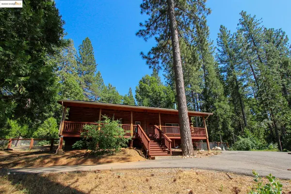 a view of a wooden deck with a backyard
