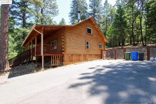 a view of house with outdoor space and sitting area