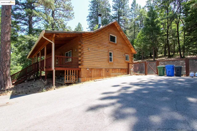 a view of house with outdoor space and sitting area