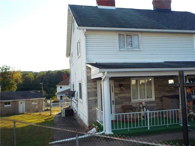 a view of a house with wooden floor and fence