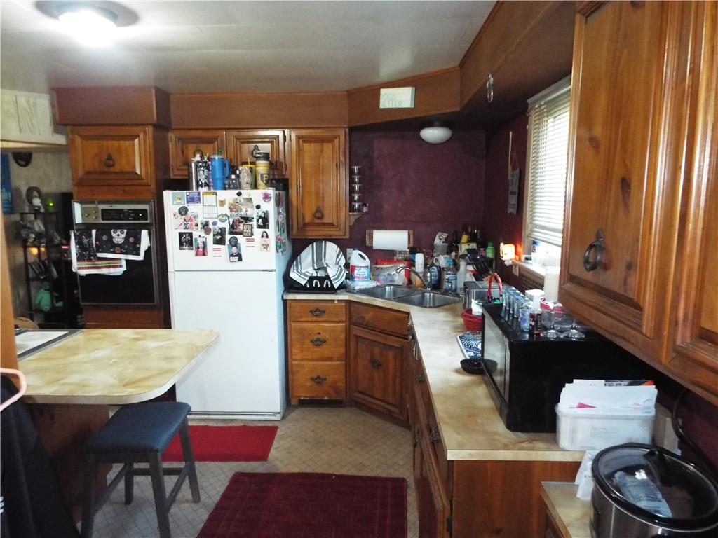 2524 2nd Street Grindstone, PA 15442 - Photo 11 of 30 a kitchen with sink refrigerator dining table and chairs