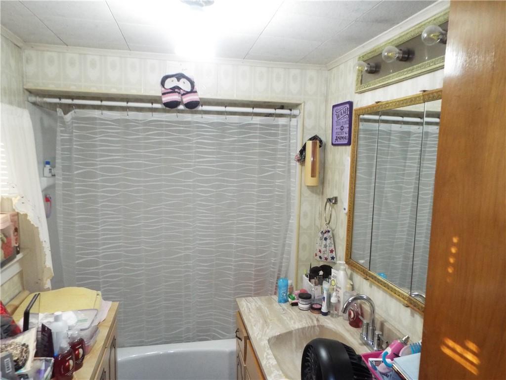 2524 2nd Street Grindstone, PA 15442 - Photo 12 of 30 a bathroom with a sink a toilet and shower curtain