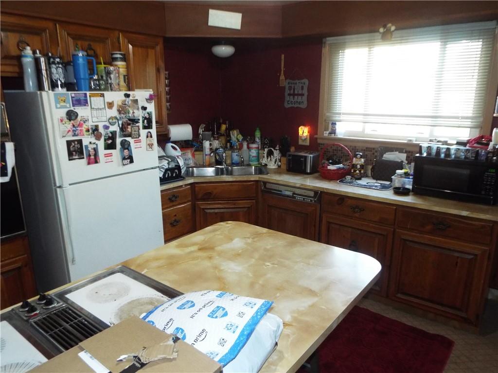 2524 2nd Street Grindstone, PA 15442 - Photo 10 of 30 a kitchen with stainless steel appliances kitchen island granite countertop a sink stove and refrigerator