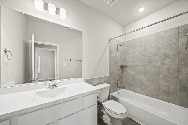 a bathroom with a sink a toilet and a bathtub