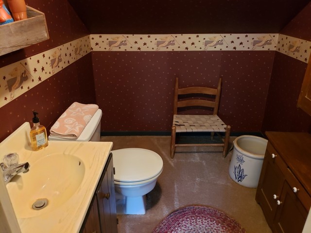 12721 Coleta Road Sterling, IL 61081 - Photo 13 of 35 a bathroom with a toilet sink and mirror