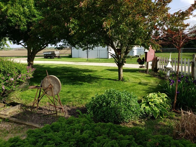 12721 Coleta Road Sterling, IL 61081 - Photo 27 of 35 a backyard of a house with lots of green space and fountain