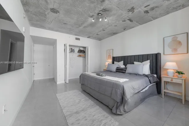 a bedroom with bed and a window