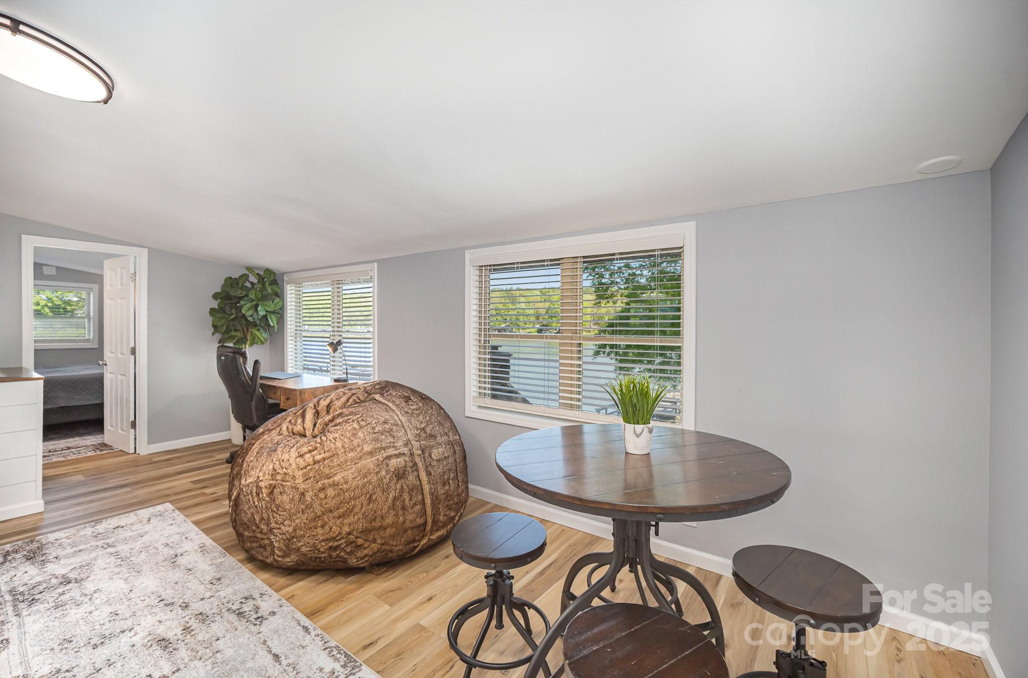 1435 Panther Point Road Richfield, NC 28137 - Photo 13 of 31 a dining room with furniture and a floor to ceiling window