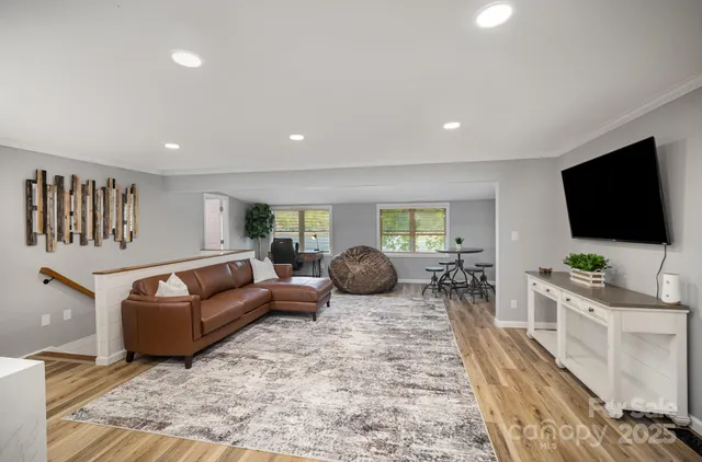 a spacious bedroom with a large bed and a flat screen tv