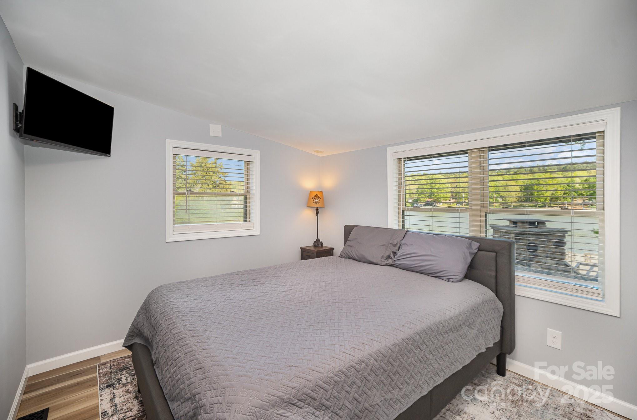 1435 Panther Point Road Richfield, NC 28137 - Photo 18 of 31 a bedroom with a bed and a flat tv screen on the dresser