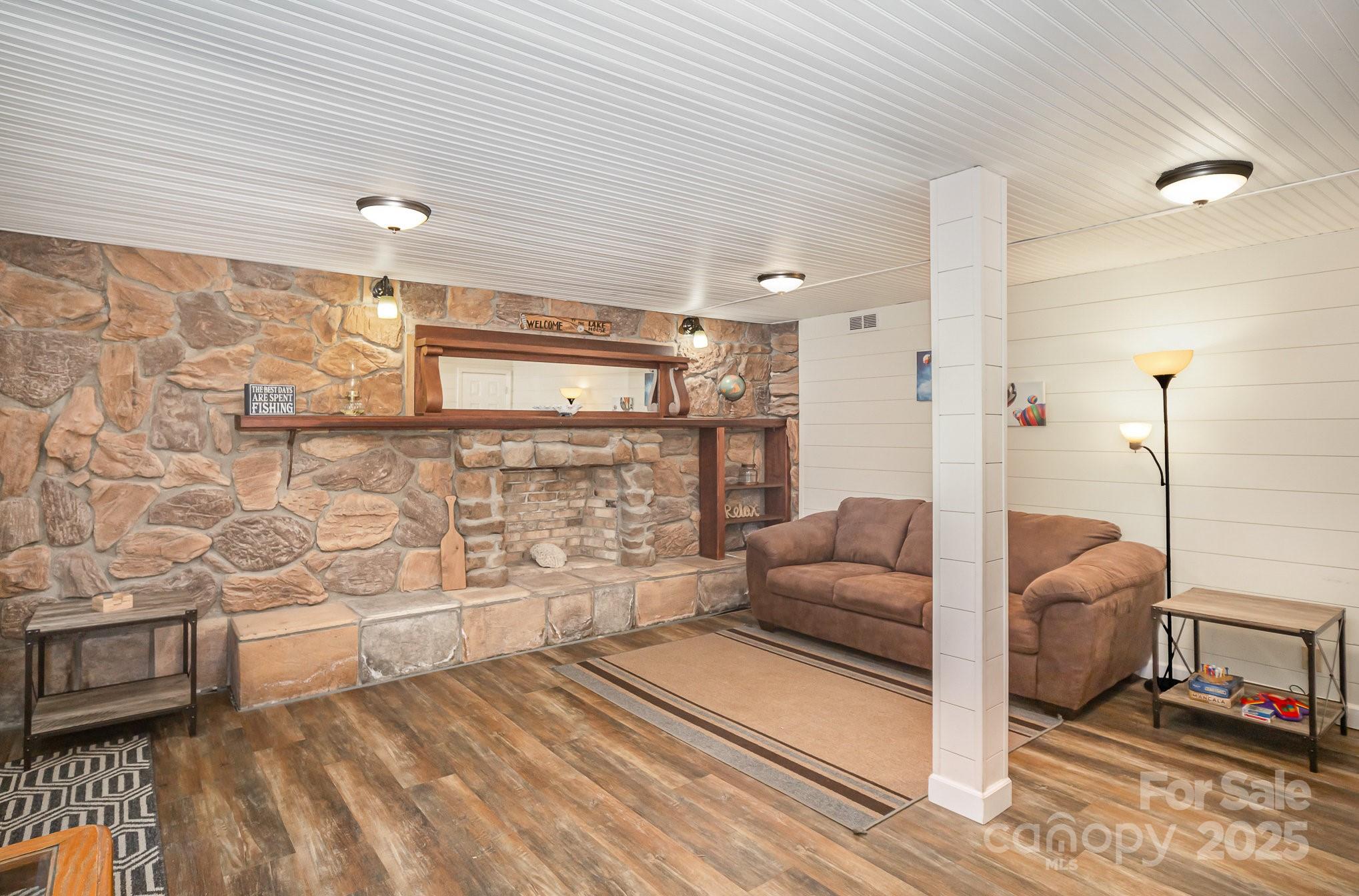 1435 Panther Point Road Richfield, NC 28137 - Photo 22 of 31 a living room with furniture and a fireplace