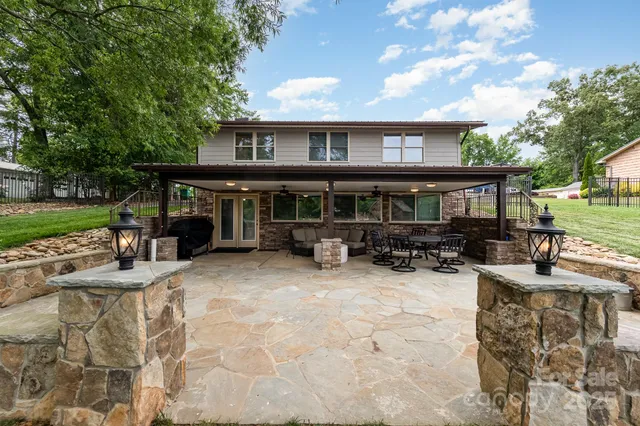 a living room with fireplace furniture and a large window
