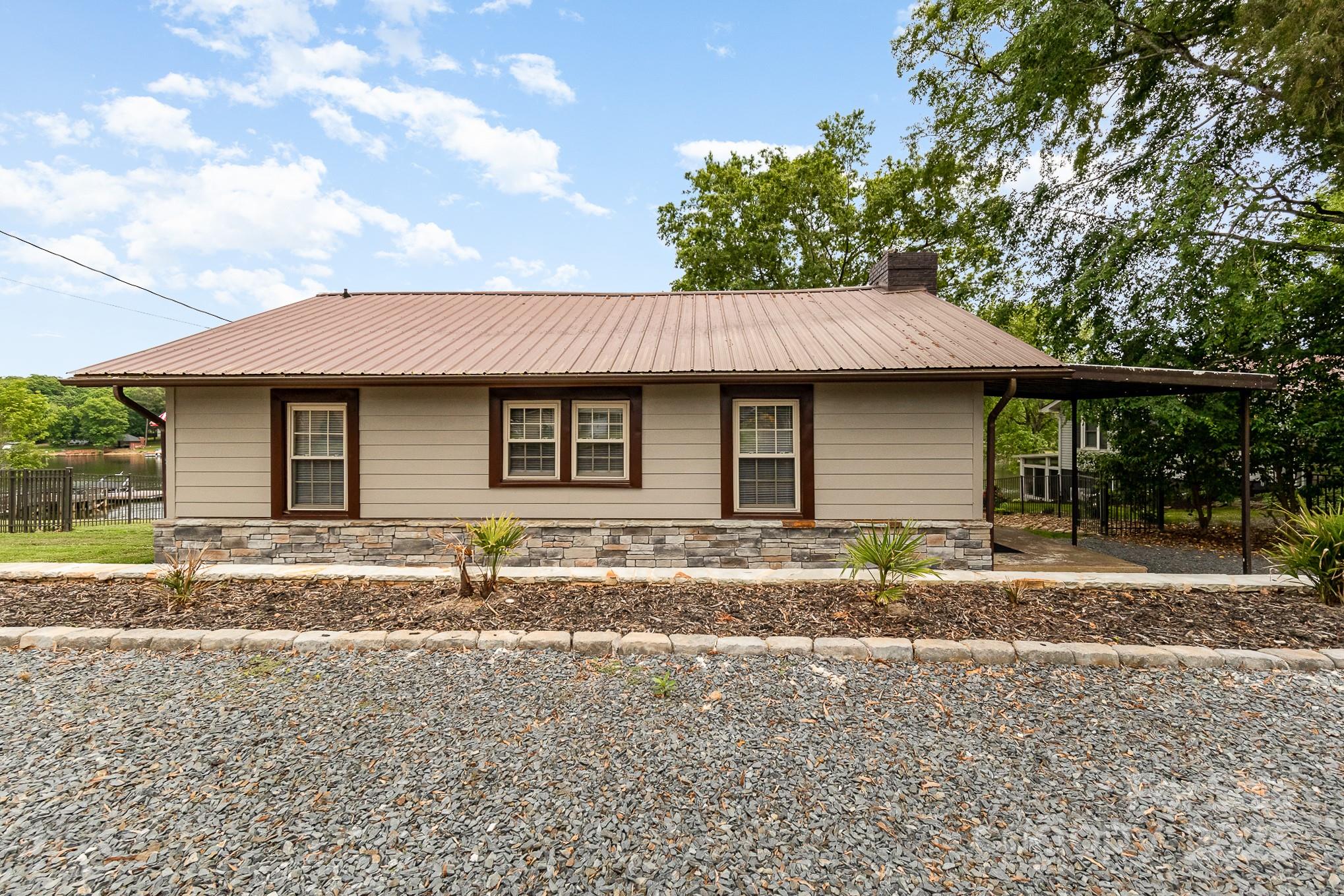 1435 Panther Point Road Richfield, NC 28137 - Photo 28 of 31 a front view of a house with a garden and yard