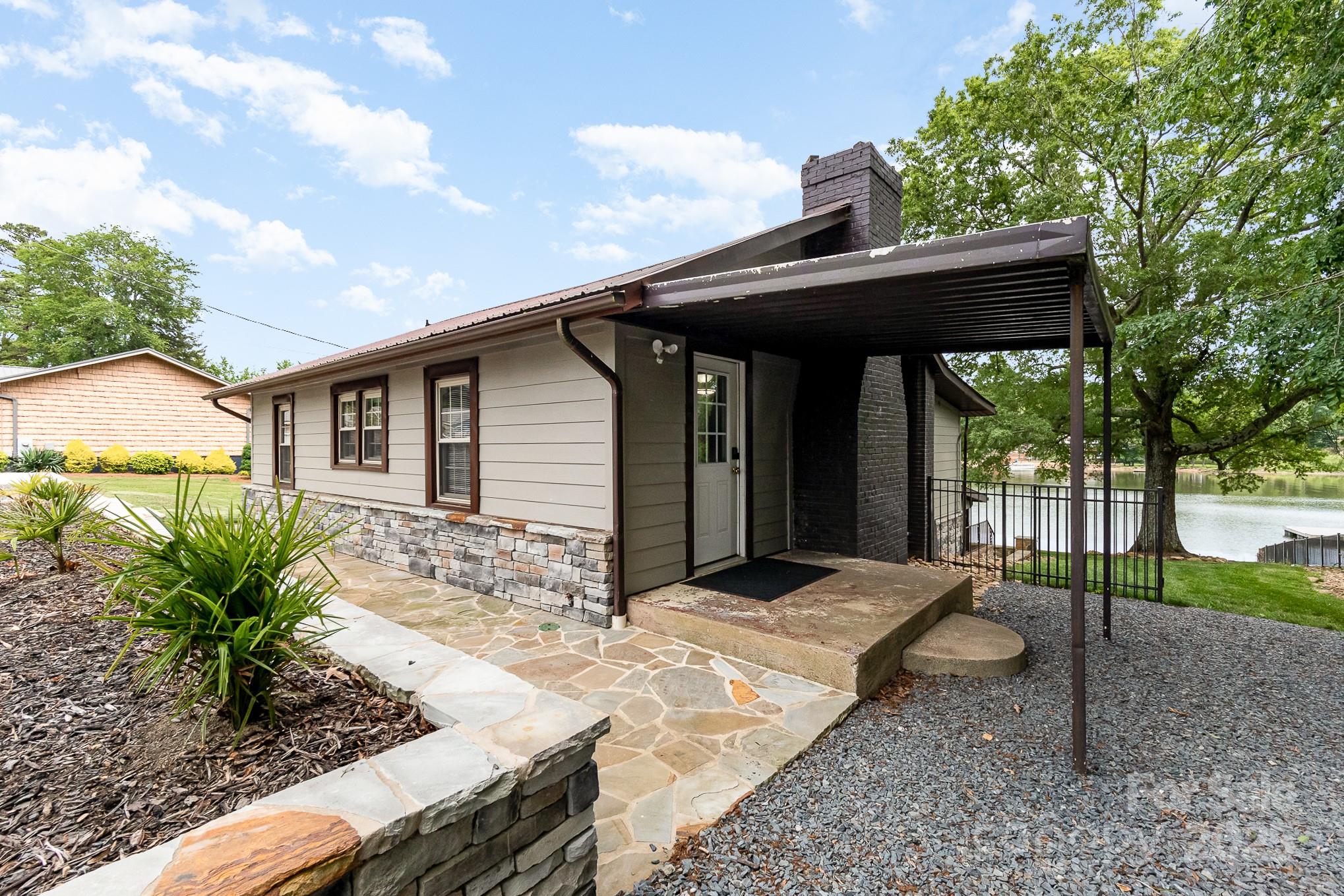 1435 Panther Point Road Richfield, NC 28137 - Photo 5 of 31 a backyard of a house with table and chairs