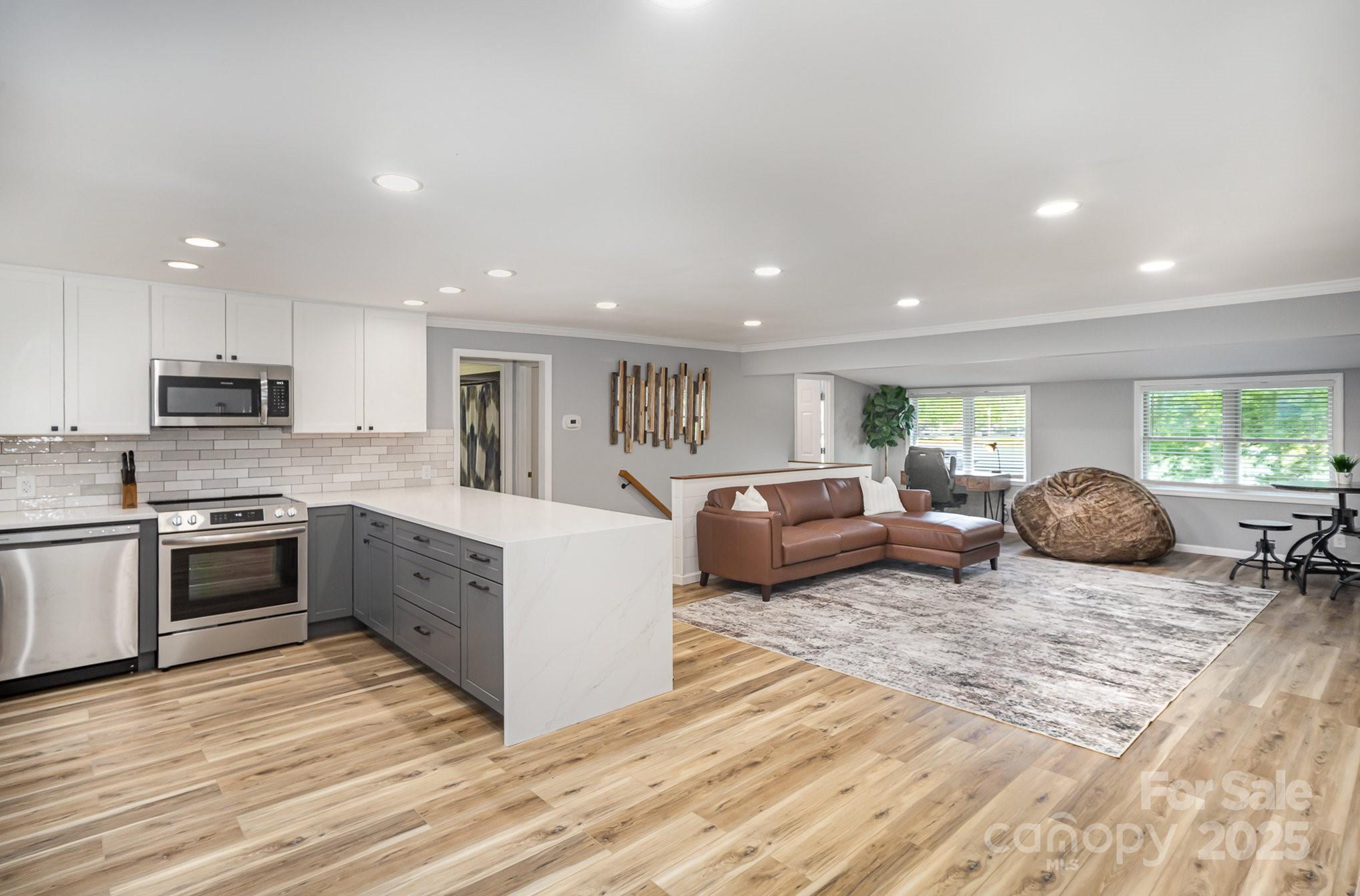 1435 Panther Point Road Richfield, NC 28137 - Photo 7 of 31 a living room with furniture a window and kitchen view