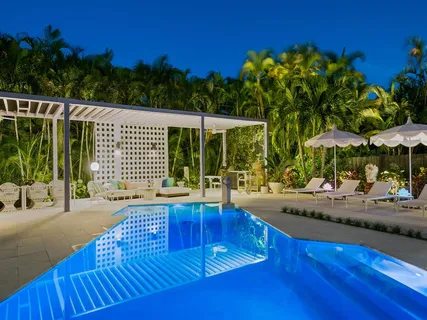 a view of a patio with swimming pool table and chairs