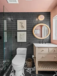 a bathroom with a toilet a sink and a shower