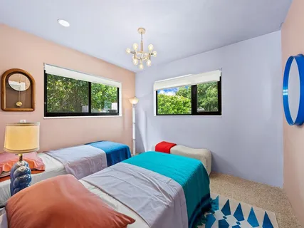 a bedroom with two beds and a chandelier