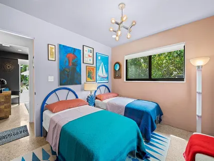 a bedroom with two beds and a window