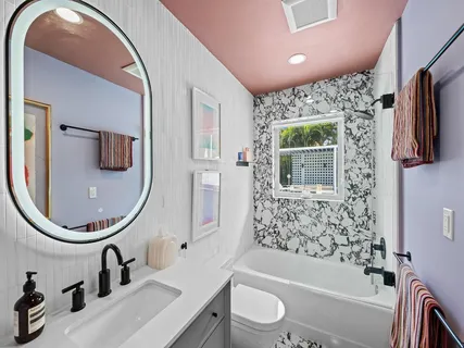 a bathroom with a sink a toilet and a mirror