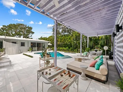 a building outdoor space with patio furniture and potted plants