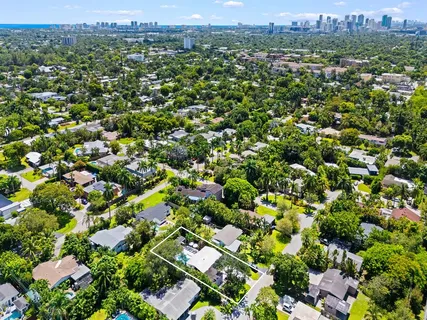 an aerial view of a houses with a yard