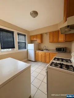 a kitchen with stainless steel appliances a stove a sink and a refrigerator