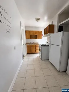a kitchen with a refrigerator and a sink