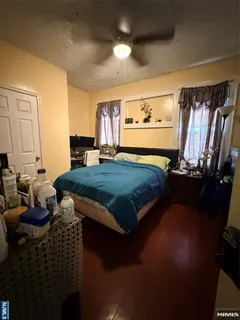a bedroom with a bed next to a window