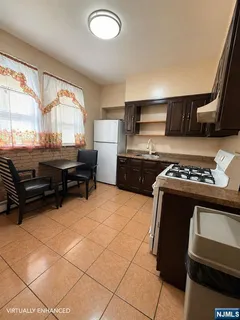 a kitchen with a stove a refrigerator and a sink