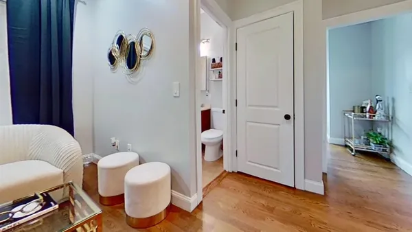 a living room with furniture and wooden floor