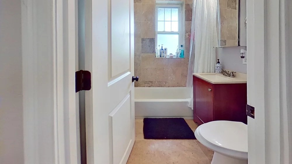 2973 Washington Street, Unit A Boston, MA 02119 - Photo 6 of 6 a bathroom with a toilet a sink and bathtub