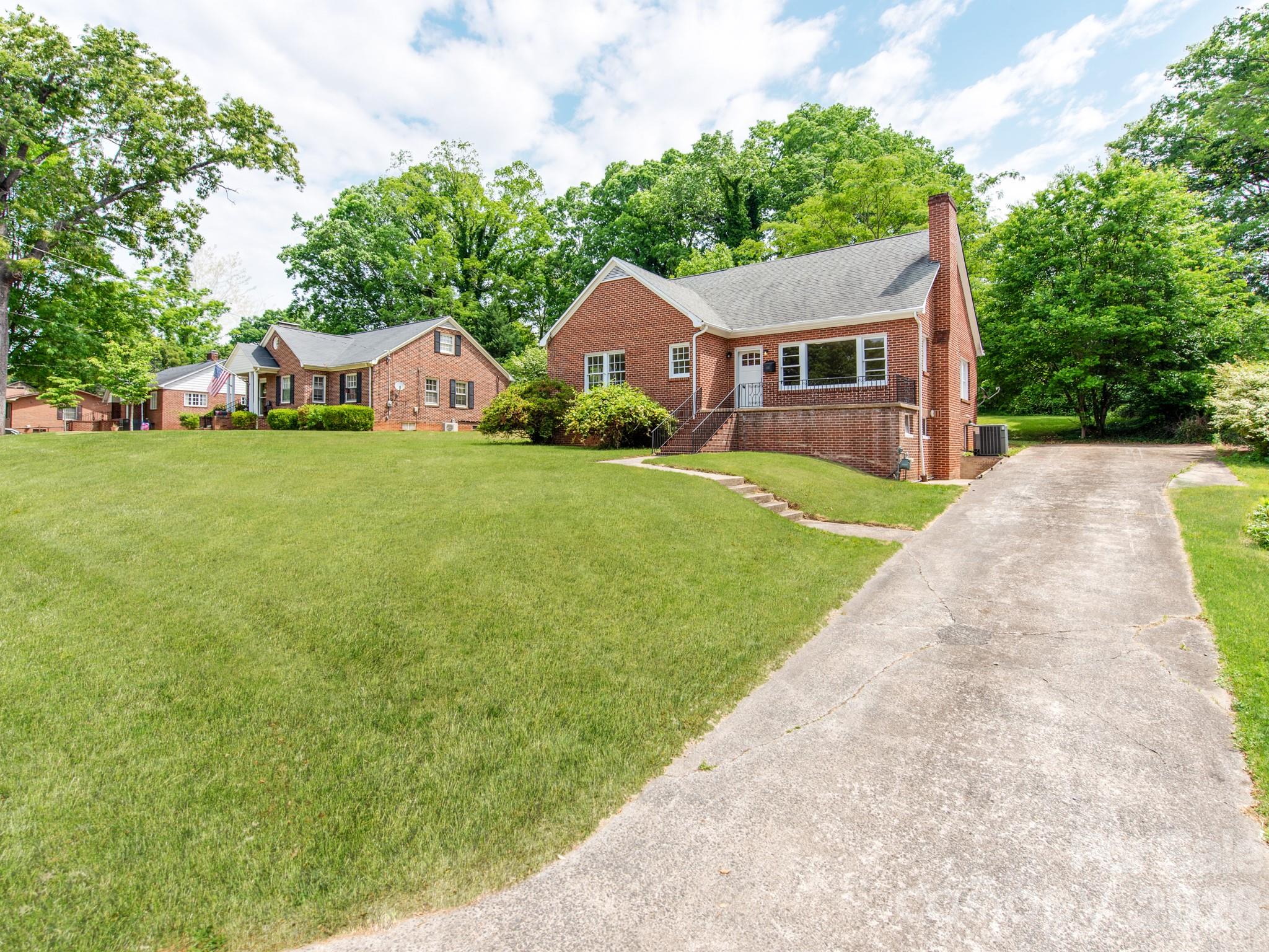 113 Falls Street Morganton, NC 28655 - Photo 2 of 33 a front view of a house with yard and green space