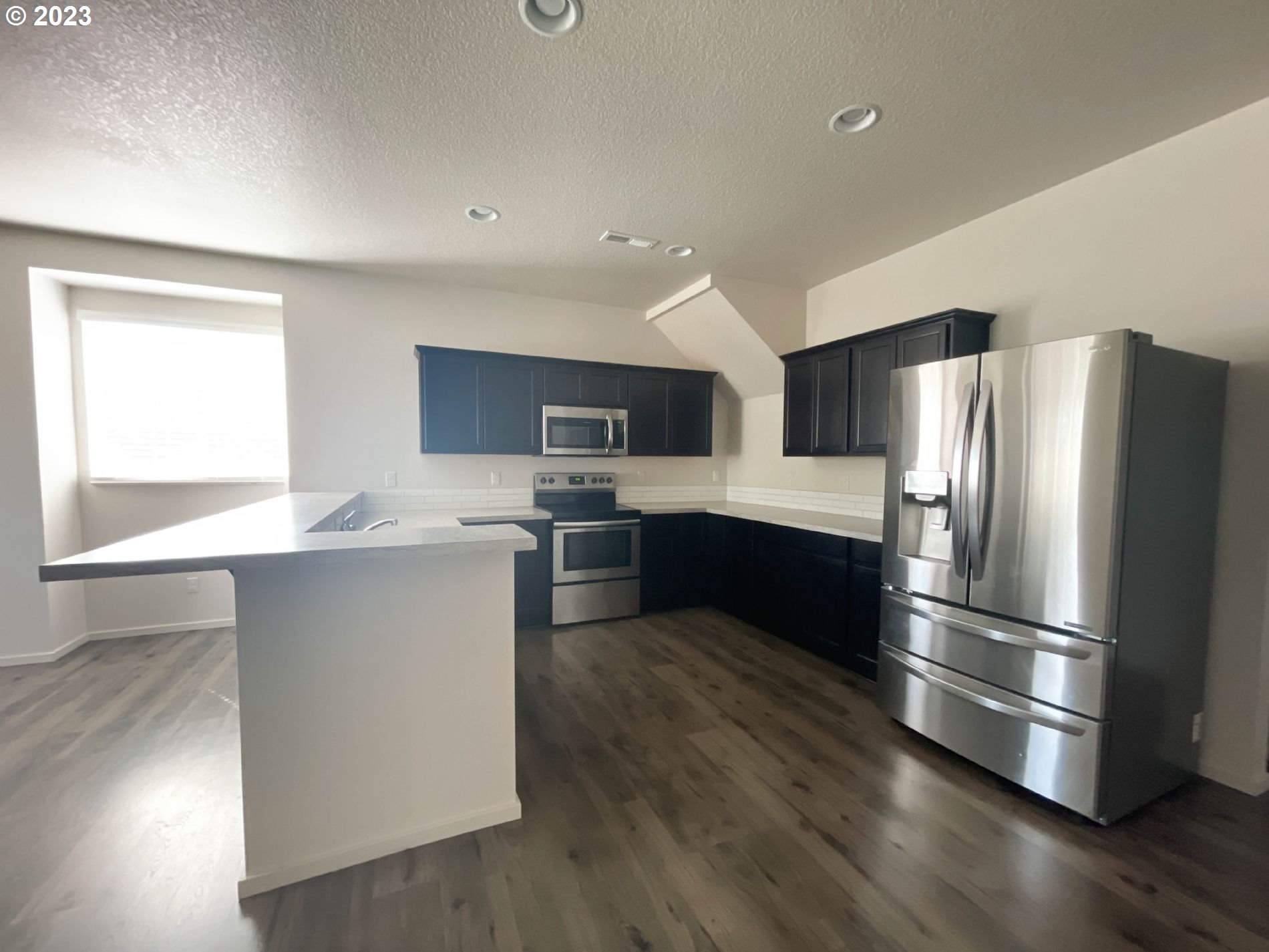 2211 Southeast 19th Street Gresham, OR 97080 - Photo 5 of 16 a kitchen with stainless steel appliances a refrigerator sink and cabinets