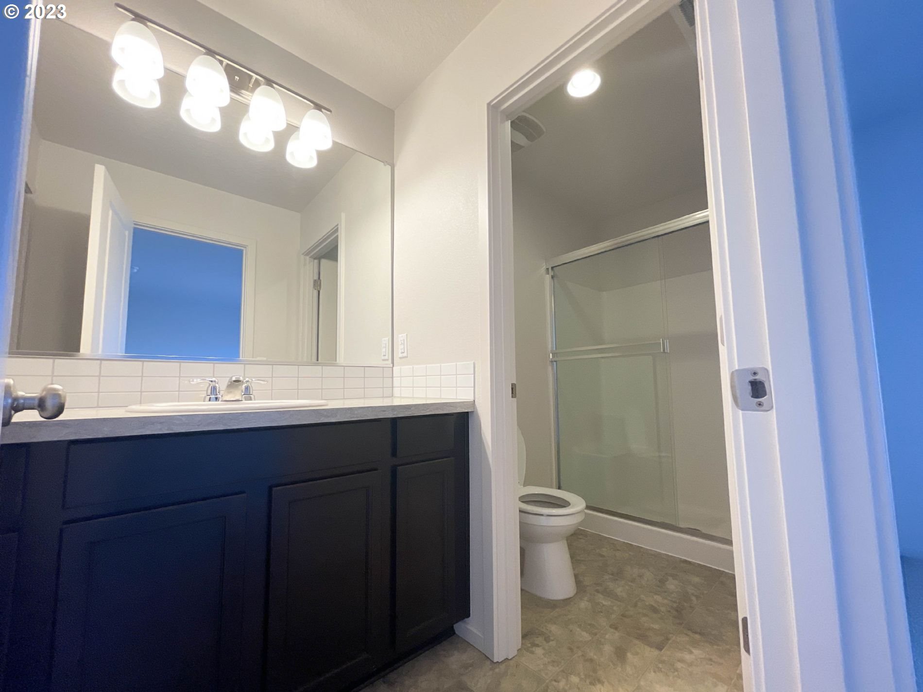 2211 Southeast 19th Street Gresham, OR 97080 - Photo 10 of 16 a bathroom with a double vanity sink toilet and a mirror