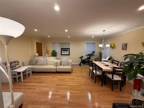 a living room with lots of furniture and a wooden floor