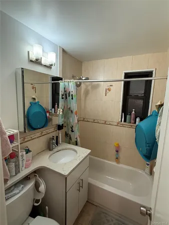 a bathroom with a sink vanity granite tub shower and mirror