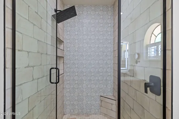 a bedroom with two beds and a large window