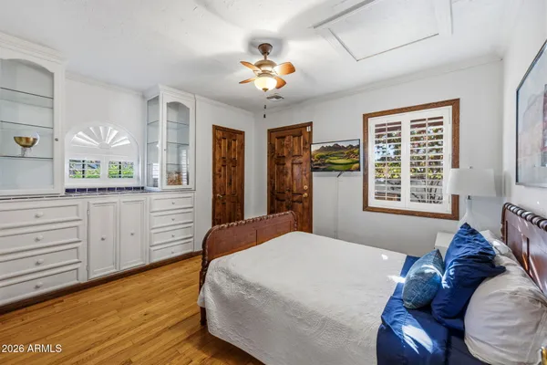 a bedroom with a bed and a chandelier