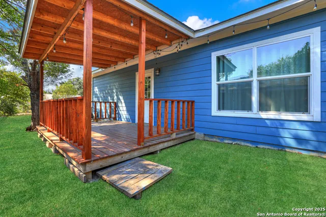 a view of a house with a yard and tree s