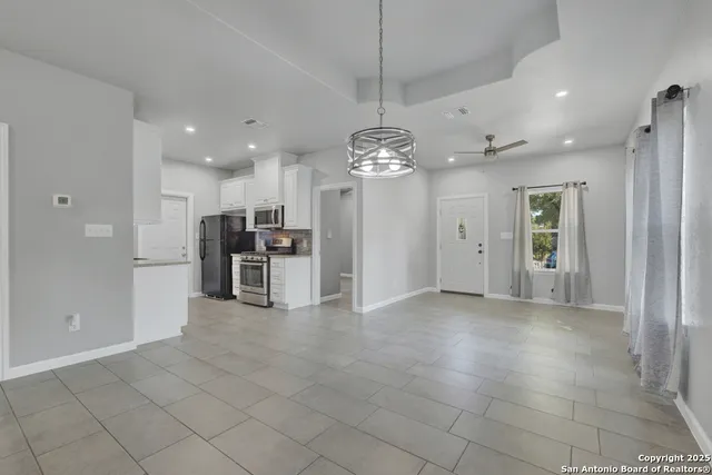 a view of a livingroom with a dinning table and chairs
