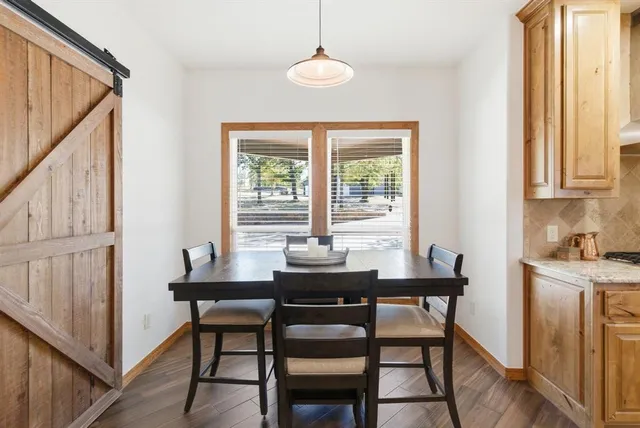 a dining room with furniture and window
