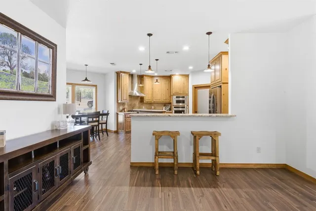 a living room with stainless steel appliances kitchen island granite countertop furniture and a kitchen view