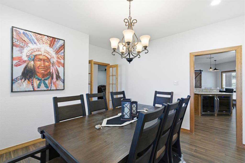 160 Falcon Drive Weatherford, TX 76088 - Photo 14 of 40 a view of a dining room with furniture wooden floor and a chandelier