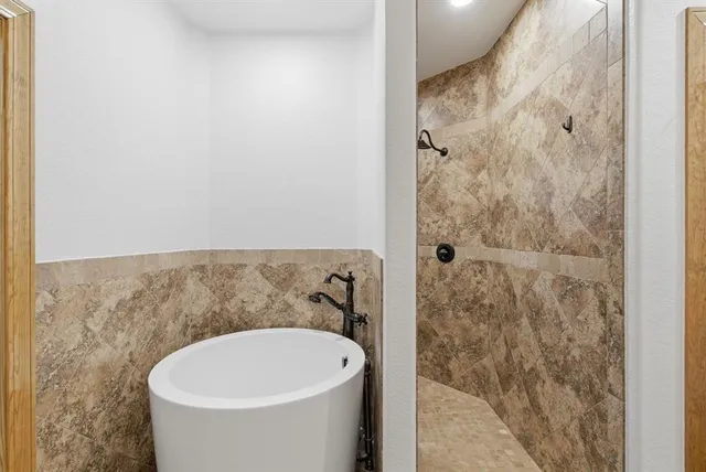 a bathroom with a bathtub and shower