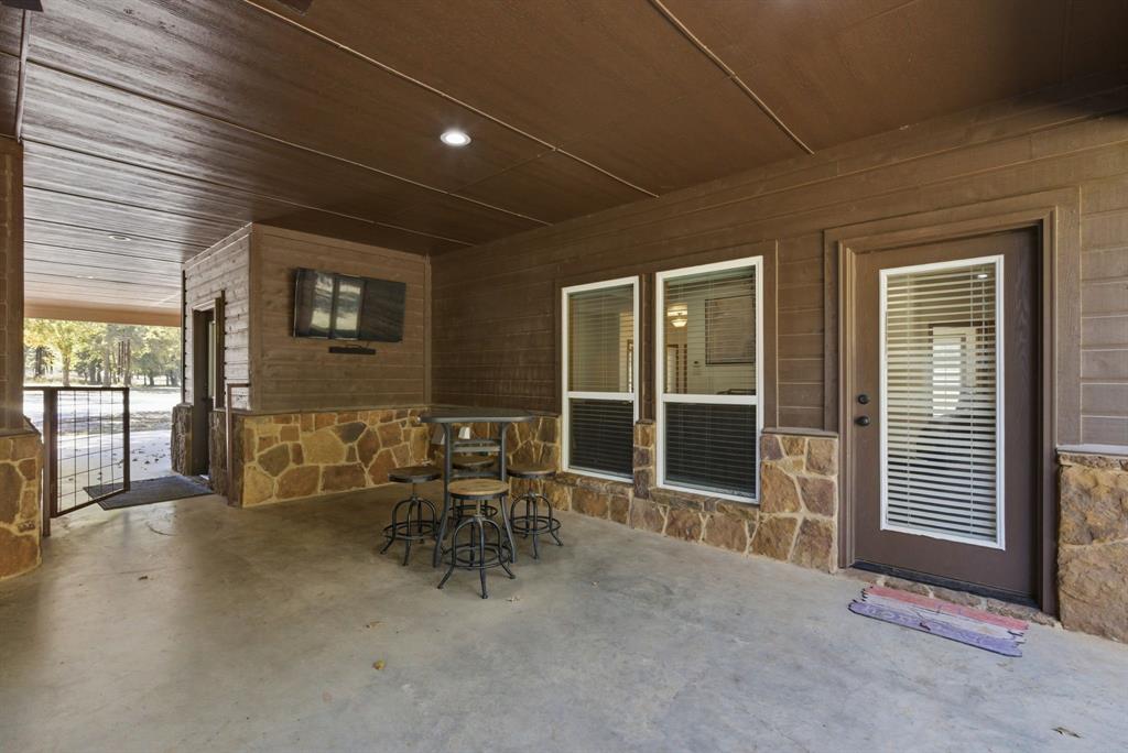 160 Falcon Drive Weatherford, TX 76088 - Photo 28 of 40 a view of a patio with table and chairs and wooden fence
