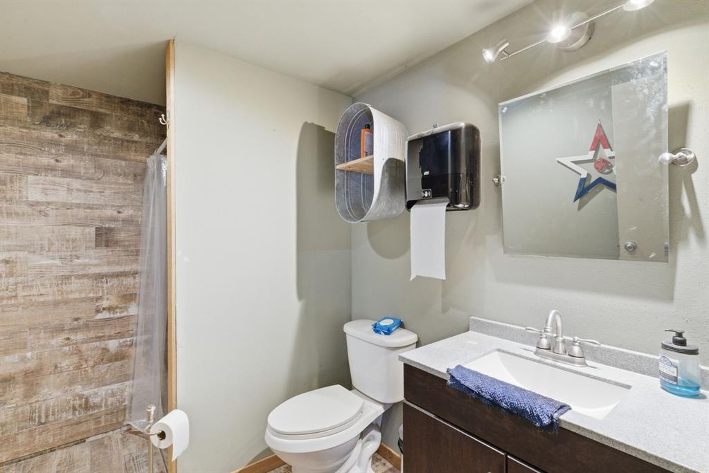 160 Falcon Drive Weatherford, TX 76088 - Photo 36 of 40 a bathroom with a granite countertop sink a toilet and a mirror