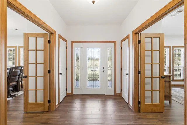 a view of a livingroom with wooden floor and windows